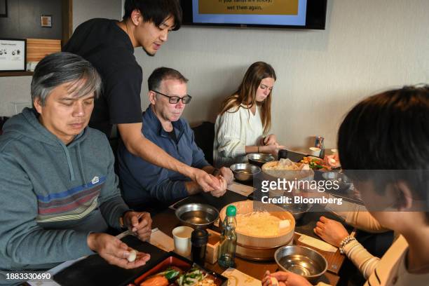 Foreign visitors learn how to make sushi in a cooking class at Sushi Making Tokyo in the Asakusa district of Tokyo, Japan, on Thursday, Dec. 28,...