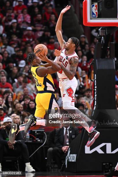Dalen Terry of the Chicago Bulls defends against a shot from Bennedict Mathurin of the Indiana Pacers in the second half on December 28, 2023 at the...