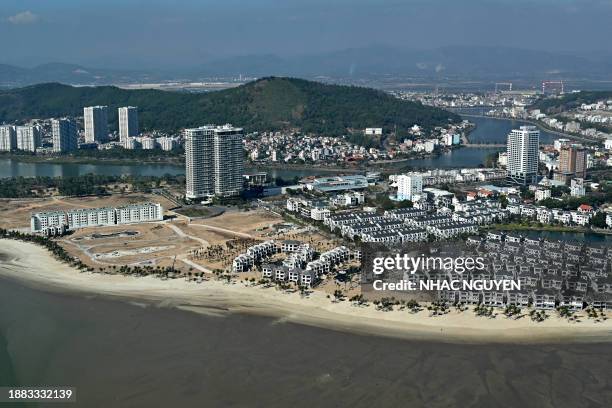 This aerial photo taken from a seaplane on December 28, 2023 shows Ha Long City next to Ha Long Bay in Vietnam's northeastern province of Quang Ninh....