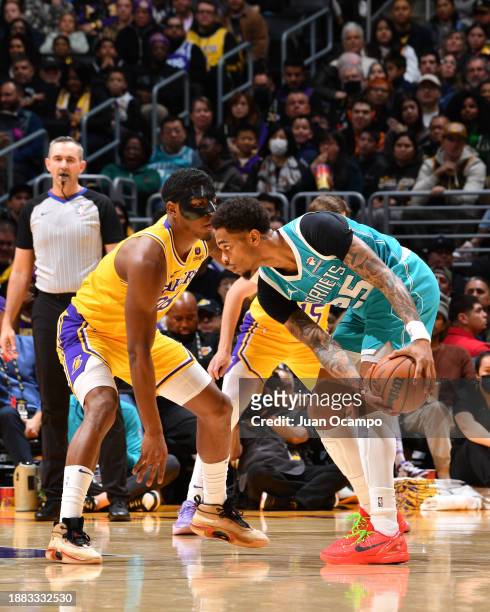 Rui Hachimura of the Los Angeles Lakers plays defense during the game against P.J. Washington of the Charlotte Hornets on December 28, 2023 at...