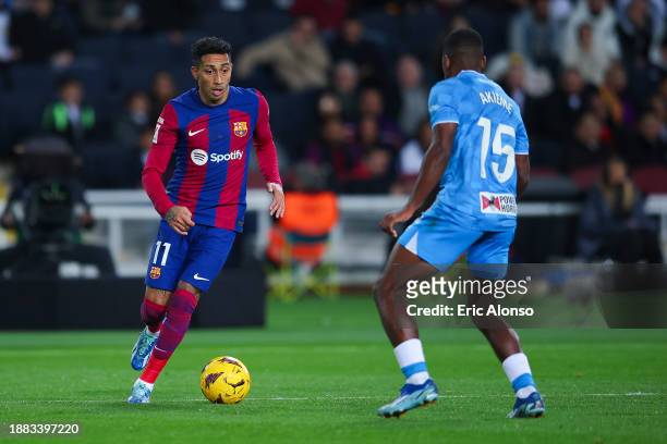Raphinha of FC Barcelona challenges for the ball against Sergio Akieme of UD Almeria during the LaLiga EA Sports match between FC Barcelona and UD...
