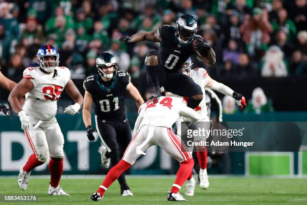Andre Swift of the Philadelphia Eagles hurdles Dane Belton of the New York Giants to avoid a tackle for a first down during the fourth quarter at...
