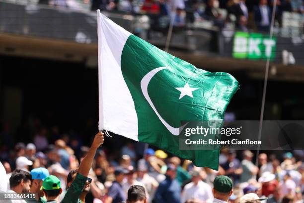 Fan holds a Pakistan flag during day one of the Second Test Match between Australia and Pakistan at Melbourne Cricket Ground on December 26, 2023 in...