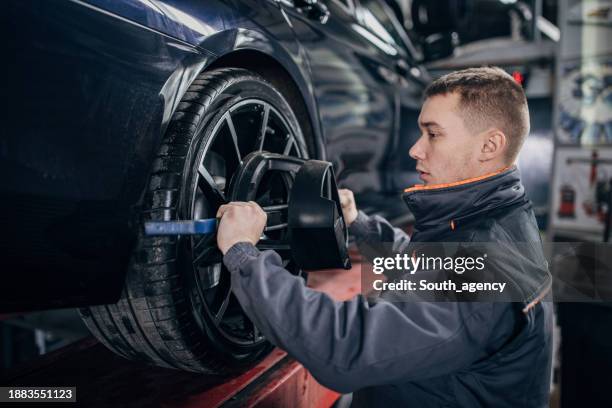 Mechanic Alignment Wheel Alignment And Balancing Photos and Premium High Res Pictures ...