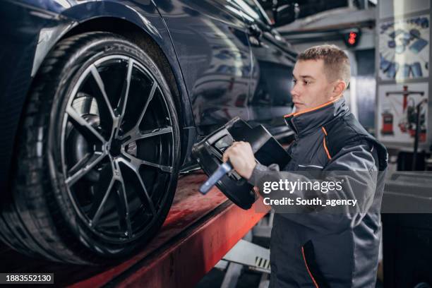 Mechanic Alignment Wheel Alignment And Balancing Photos and Premium High Res Pictures ...