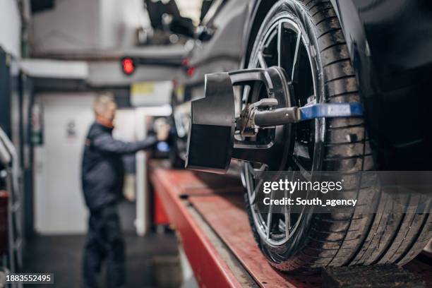 Mechanic Alignment Wheel Alignment And Balancing Photos and Premium High Res Pictures ...