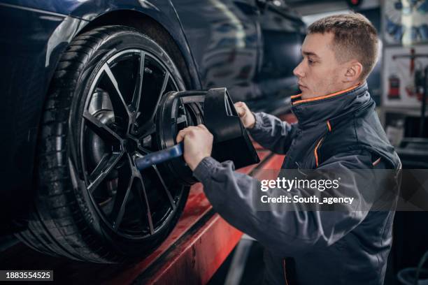Mechanic Alignment Wheel Alignment And Balancing Photos and Premium High Res Pictures ...