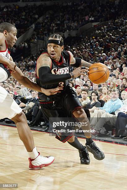 Allen Iverson of the Philadelphia 76ers drives the baseline around Antonio Daniels of the Portland Trail Blazers during the game at The Rose Garden...