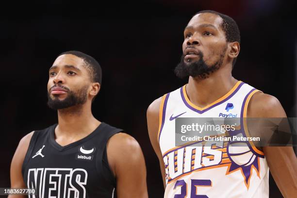 Kevin Durant of the Phoenix Suns and Mikal Bridges of the Brooklyn Nets during the NBA game at Footprint Center on December 13, 2023 in Phoenix,...