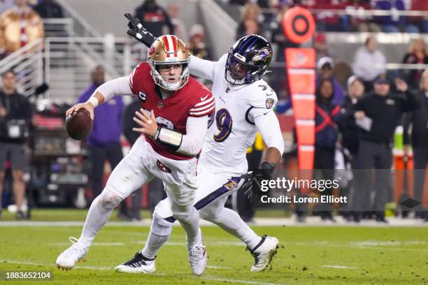 Brock Purdy of the San Francisco 49ers attempts a pass while pressured by Odafe Oweh of the Baltimore Ravens during the second quarter at Levi's...