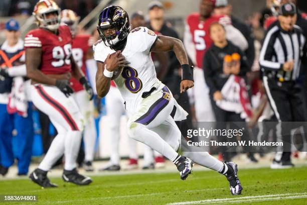 Lamar Jackson of the Baltimore Ravens runs the ball during the second quarter against the San Francisco 49ers at Levi's Stadium on December 25, 2023...