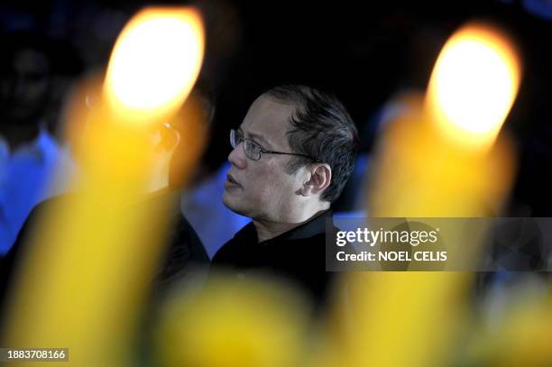 Incoming president Benigno Aquino listens during a mass at the tomb of his parents, democracy icon Corazon Aquino and senator Benigno Aquino at the...