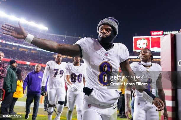 Lamar Jackson of the Baltimore Ravens high fives a fan while heading into the locker room after the first half against the San Francisco 49ers at...