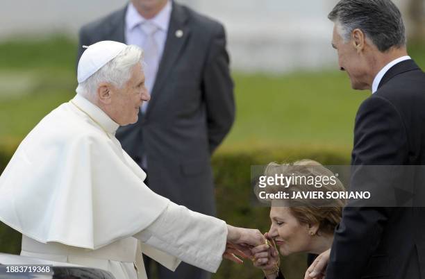 Maria Cavaco Silva , the wife of Portuguese President Anibal Cavaco Silva , kisses the hand of Pope Benedict XVI during a visit to the Jeronimos...