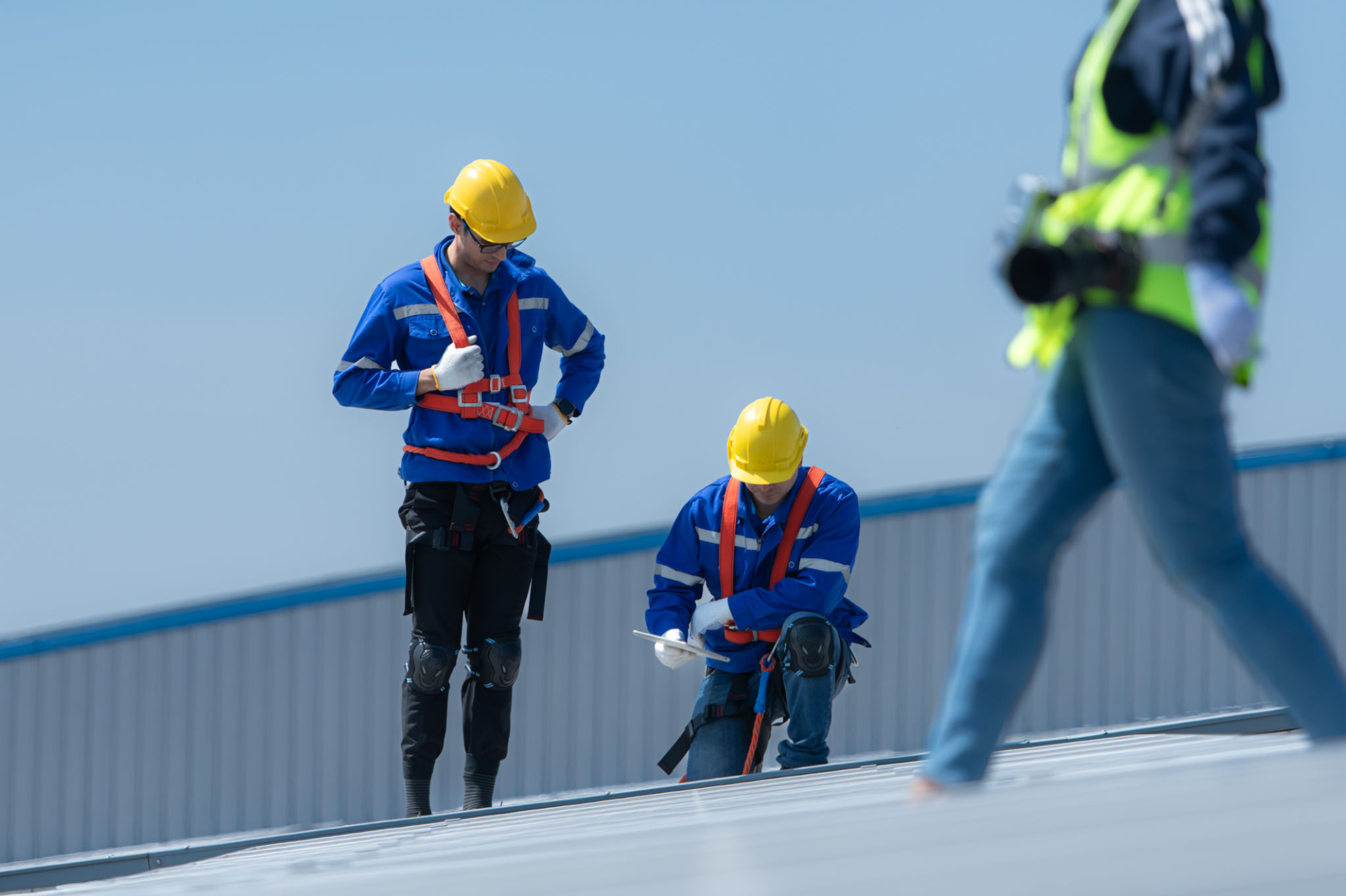 technicians is installing solar panels on the roof of the warehouse technicians is installing solar panels on the roof of the warehouse