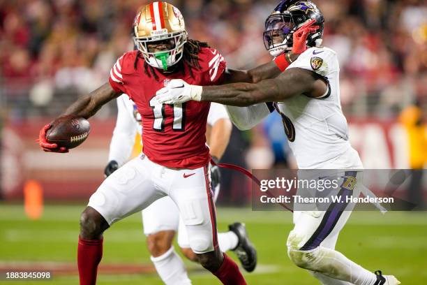 Brandon Aiyuk of the San Francisco 49ers stiff armed Patrick Queen of the Baltimore Ravens during the fourth quarter at Levi's Stadium on December...