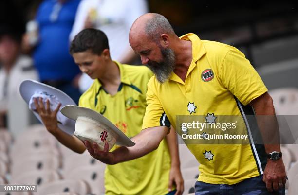 Fans tilt their hat in honour of Shane Warne during the rain delay on day one of the Second Test Match between Australia and Pakistan at Melbourne...