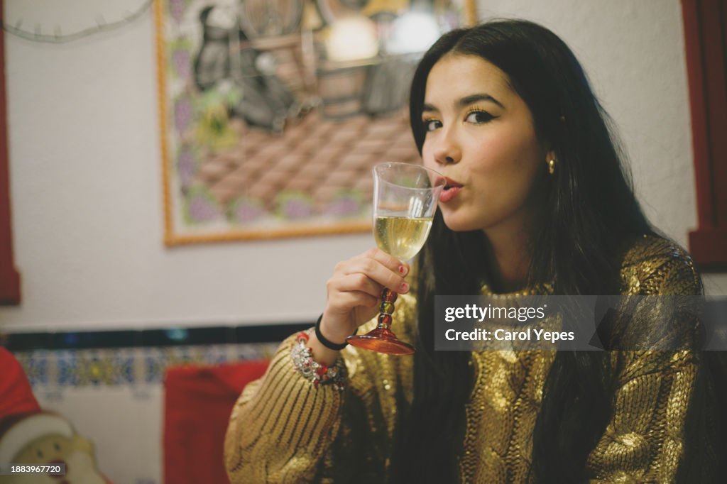 New years female teenager in elegant dress toasting