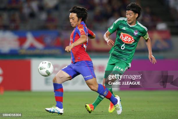 Shoya Nakajima of FC Tokyo controls the ball against Yuki Kobayashi of Albirex Niigata during the J.League J1 first stage match between FC Tokyo and...