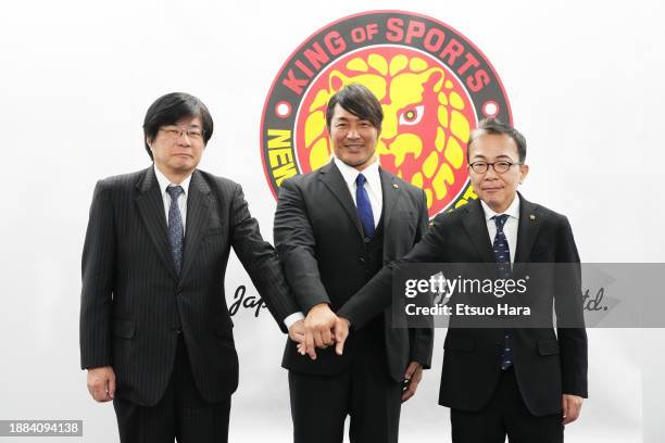 New Japan Pro-Wrestling President Hiroshi Tanahashi pose with Takaaki Kidani and Hitoshi Matsumoto in front of the NJPW branding during the New Japan...