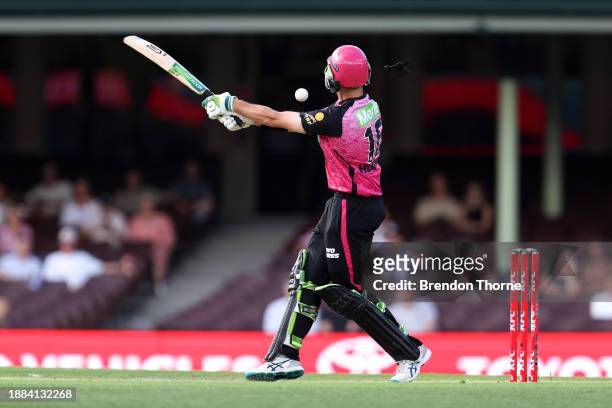 Daniel Hughes of the Sixers is hit on the helmet during the BBL match between Sydney Sixers and Melbourne Stars at Sydney Cricket Ground, on December...