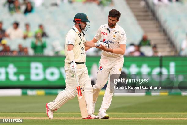 Shaheen Shah Afridi of Pakistan checks on Travis Head of Australia after striking him with the ball during day one of the Second Test Match between...