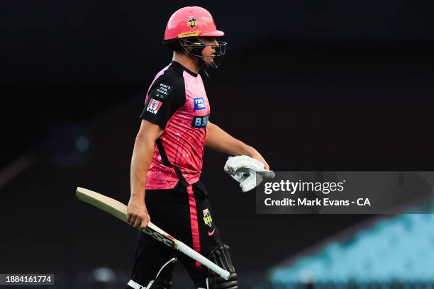 Moises Henriques of the Sixers walks off after being caught out by Sam Harper of the Stars bowled by Usama Mir of the Stars during the BBL match...