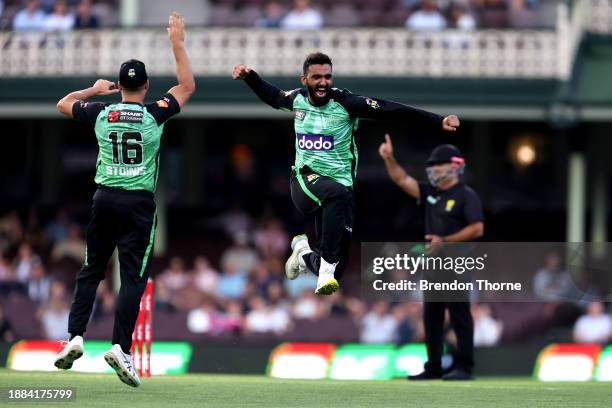 Usama Mir of the Stars celebrates with team mate Marcus Stoinis after claiming the wicket of Jordan Silk of the Sixers during the BBL match between...