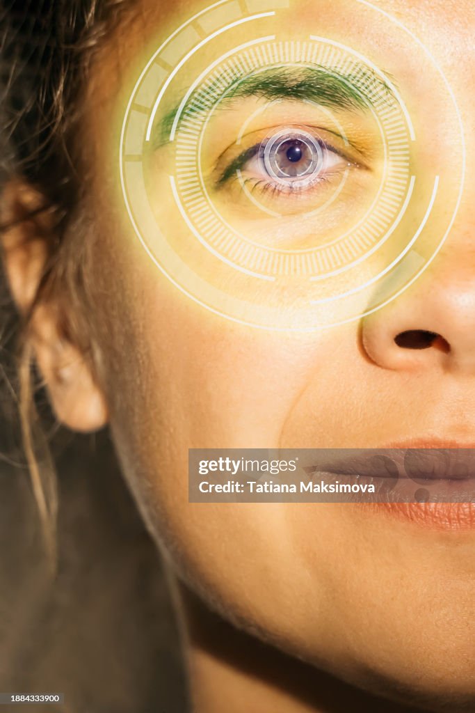 Half of a woman's face close-up with cyber eye with diagram. Concept of futurism, cyber eye and smart lens instead of a smartphone.