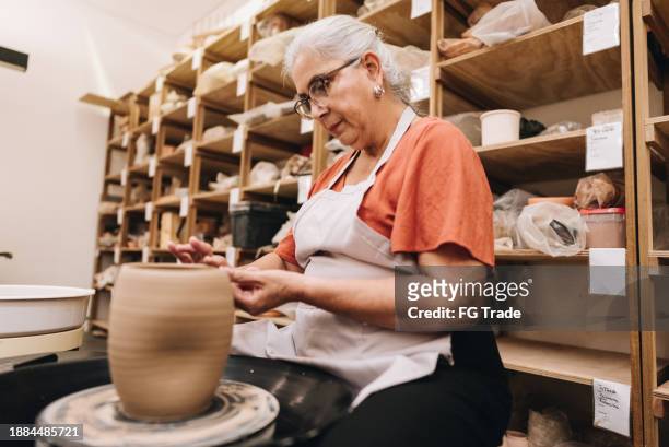 senior woman making a craft product of ceramic - art and craft stock pictures, royalty-free photos & images