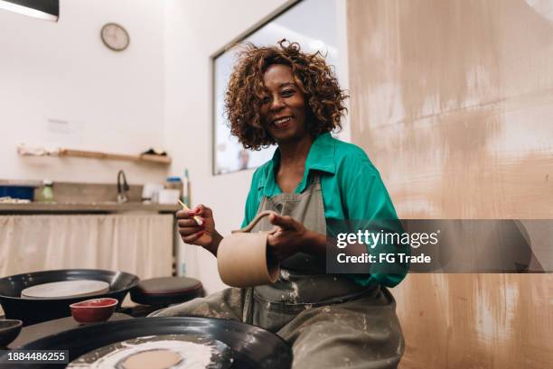 portrait of a senior woman making a craft product of ceramic - earthenware stock pictures, royalty-free photos & images