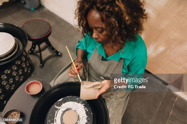 senior woman making a craft product of ceramic - black sculptor stock pictures, royalty-free photos & images