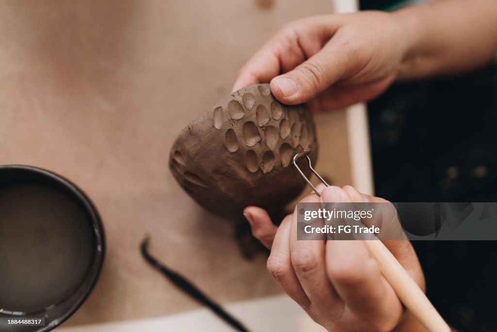 Close-up of a woman making a craft product of ceramic