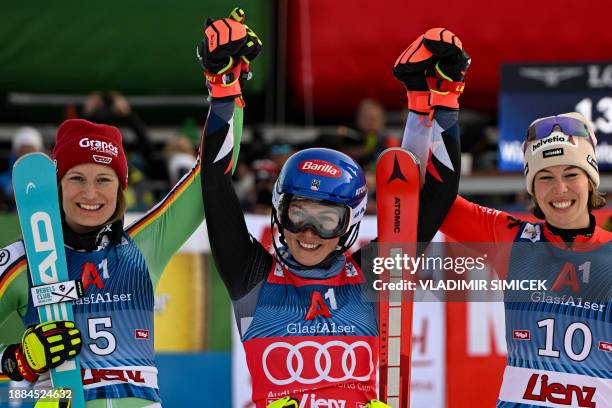 Winner US' Mikaela Shiffrin , runner-up Germany's Lena Duerr and third placed Switzerland's Michelle Gisin pose for a picture after the Women's...
