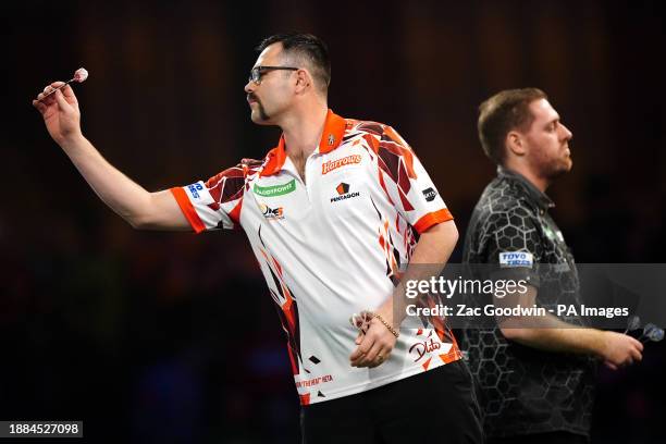 Damon Heta in action against Berry van Peer on day twelve of the Paddy Power World Darts Championship at Alexandra Palace, London. Picture date:...