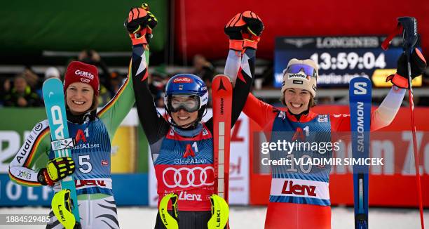 Winner US' Mikaela Shiffrin , runner-up Germany's Lena Duerr and third placed Switzerland's Michelle Gisin pose for a picture after the Women's...