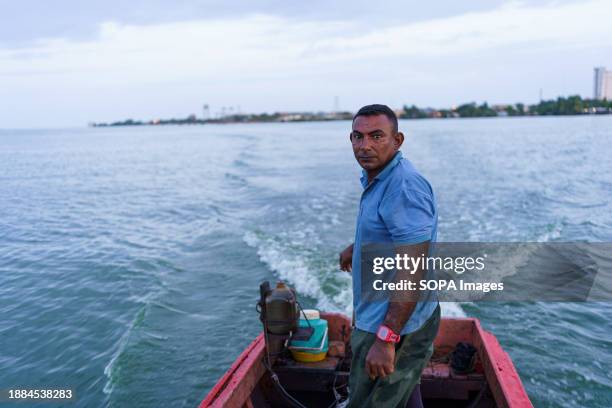 Fisherman is seen driving his fishing boat in Lake Maracaibo. After being exploited for intense oil extraction for decades, Lake Maracaibo has become...