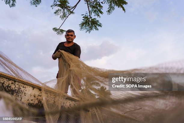 Fisherman is preparing his nets before fishing in Lake Maracaibo. After being exploited for intense oil extraction for decades, Lake Maracaibo has...