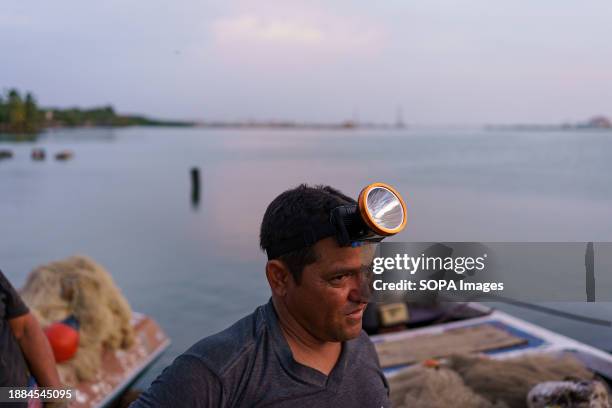 Fisherman wearing a headlamp is seen near the Lake Maracaibo. After being exploited for intense oil extraction for decades, Lake Maracaibo has become...
