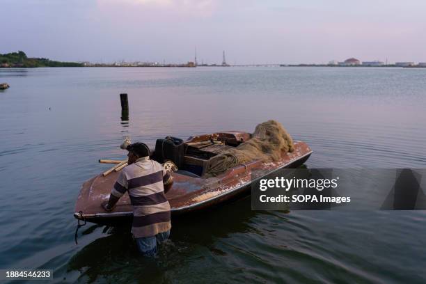 Man is seen moving his fishing boat over the waters of Lake Maracaibo. After being exploited for intense oil extraction for decades, Lake Maracaibo...