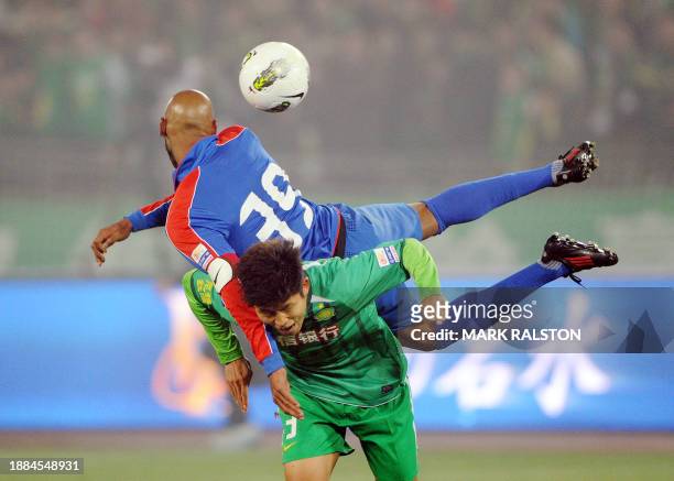 French International player Nicolas Anelka from the Shanghai Shenhua club clashes with opponent Yu Yang during Shanghai Shenhua's 2-3 league match...