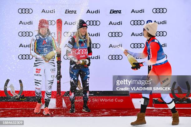 Winner US' Mikaela Shiffrin , runner-up Germany's Lena Duerr and third placed Switzerland's Michelle Gisin celebrate on the podium after the Women's...