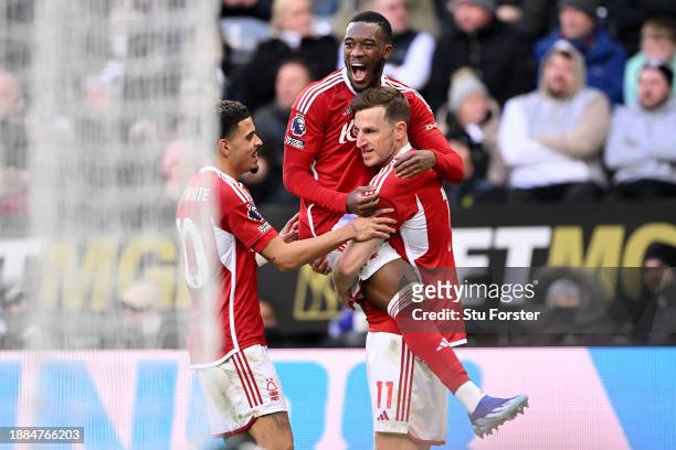 Chris Wood of Nottingham Forest celebrates with team mates Morgan Gibbs-White and Callum Hudson-Odoi after scoring their sides third goal during the...