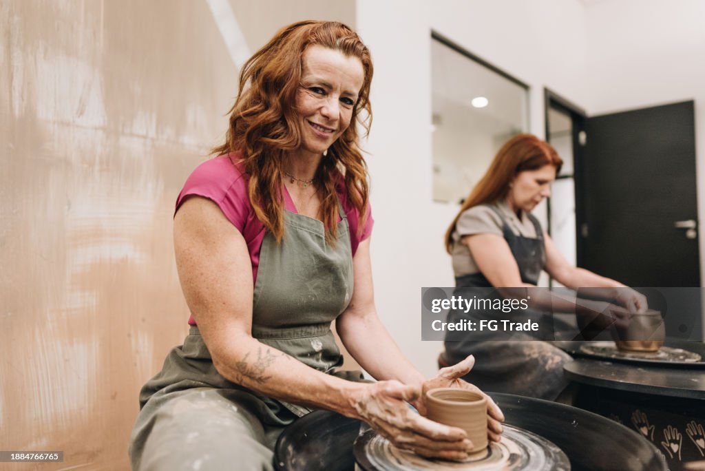 Portrait of a mature woman on pottery class at a ceramics workshop