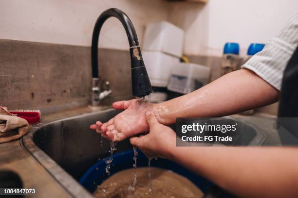 close-up of a woman washing hands at a ceramics industry - rubbing hands together stock pictures, royalty-free photos & images