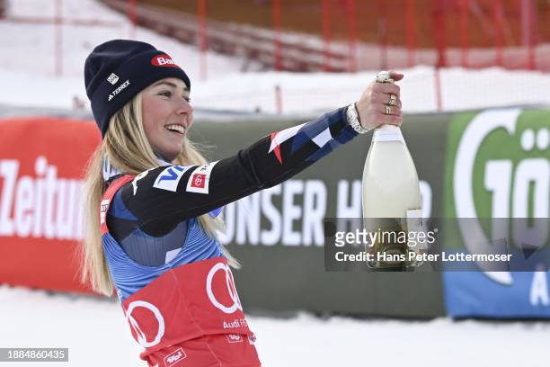 Mikaela Shiffrin of the United States poses with a bottle of champagne of the Women's Slalom during the flower ceremony Audi FIS Alpine Ski World Cup...