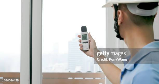 man use sound level meter - contatore foto e immagini stock