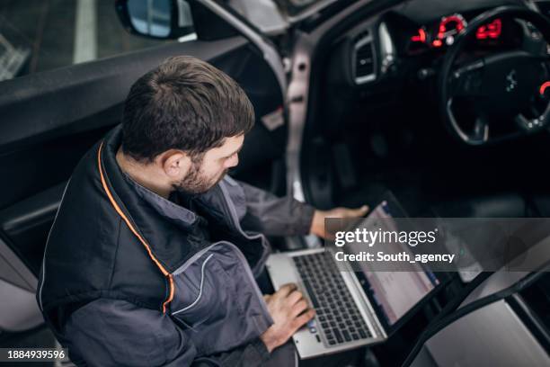 mechanic doing car diagnostic in auto repair shop - kontroll bildbanksfoton och bilder