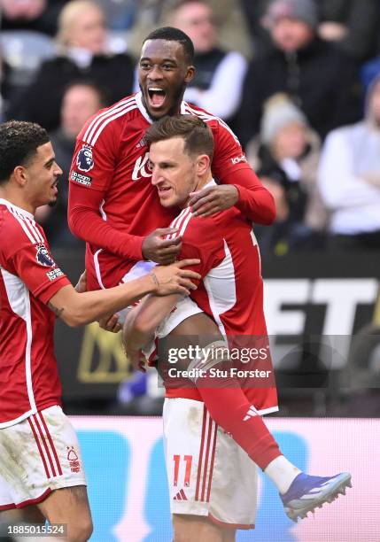 Chris Wood of Nottingham Forest celebrates his hat trick goal with team mates Morgan Gibbs-White and Callum Hudson-Odoi after scoring their sides...