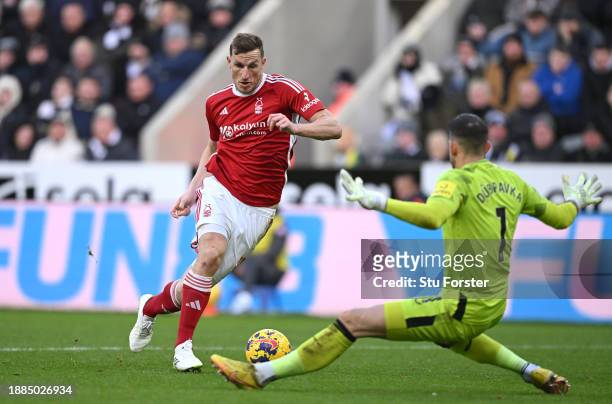 Chris Wood of Nottingham Forest rounds Newcastle goalkeeper Martin Dubravka to score his sides third goal and complete his hat trick during the...